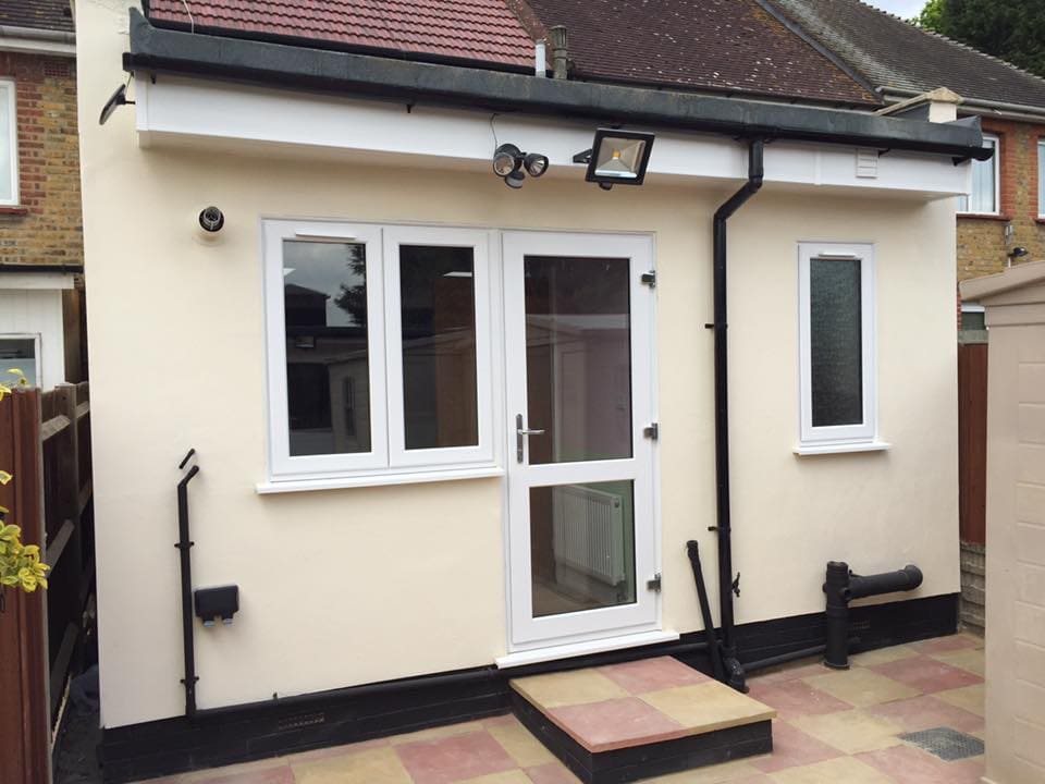 Cream rendered extension with French doors onto paving