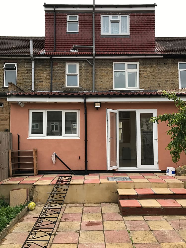 Pink rendered rear extension with French doors
