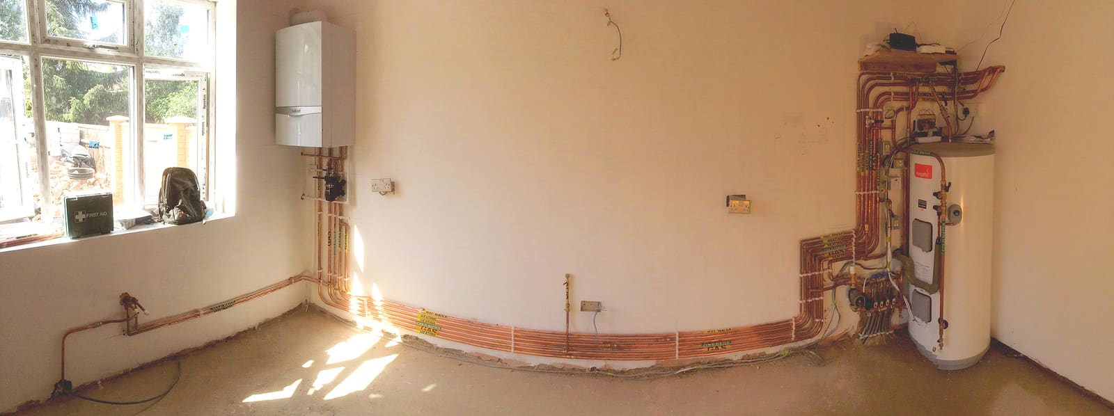 Boiler and chased pipework during heating installation