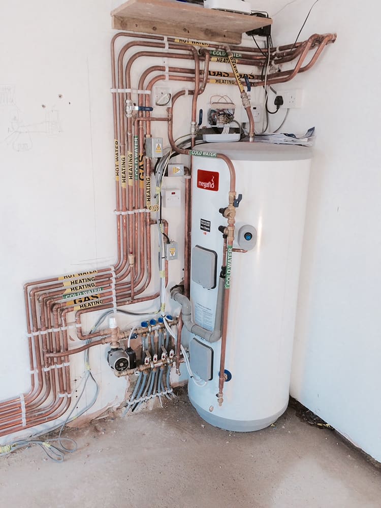 Unvented hot water cylinder installed with new pipework