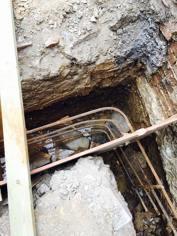 Deep excavation pit showing London clay and existing footings