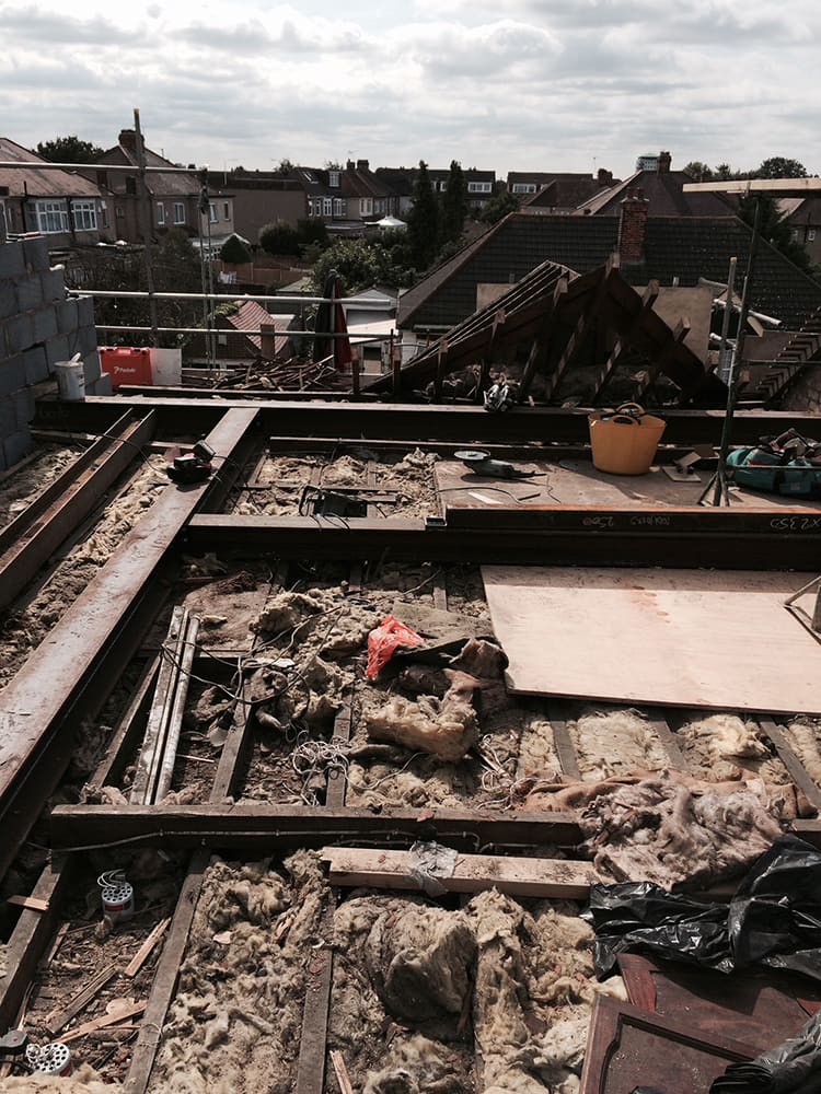 Stripped roof structure with debris and exposed joists