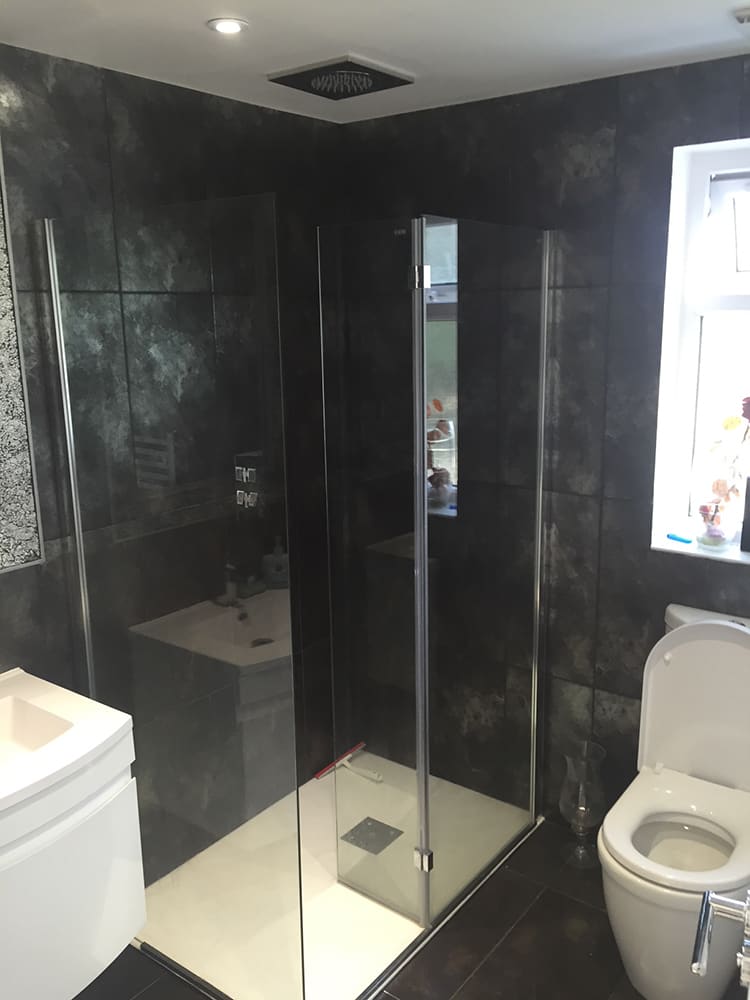 Dark marble-effect tiled bathroom with wall-hung WC