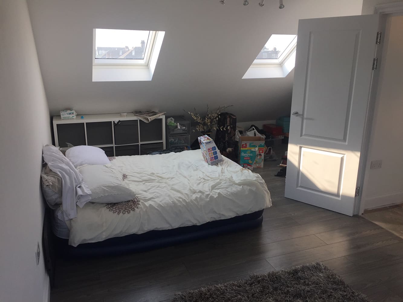 Finished loft bedroom with two rooflights and fitted flooring