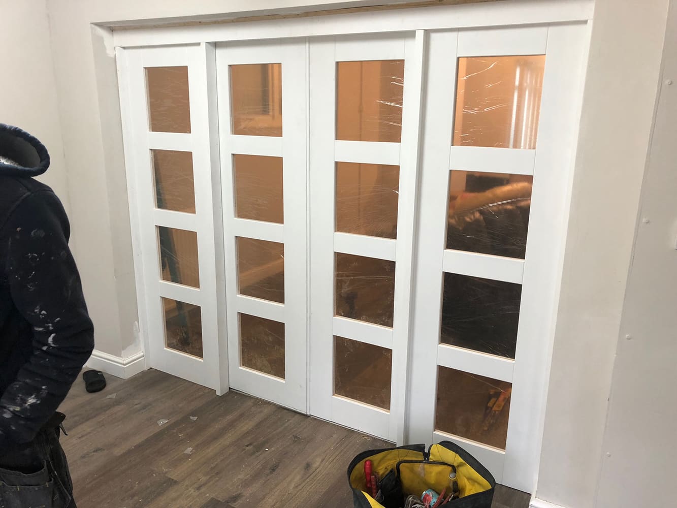 Internal white glazed folding doors dividing living spaces