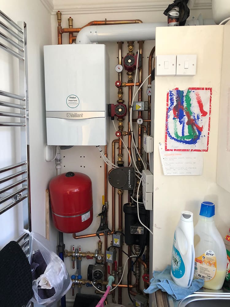 New boiler and expansion vessel installed, child's drawing on the wall