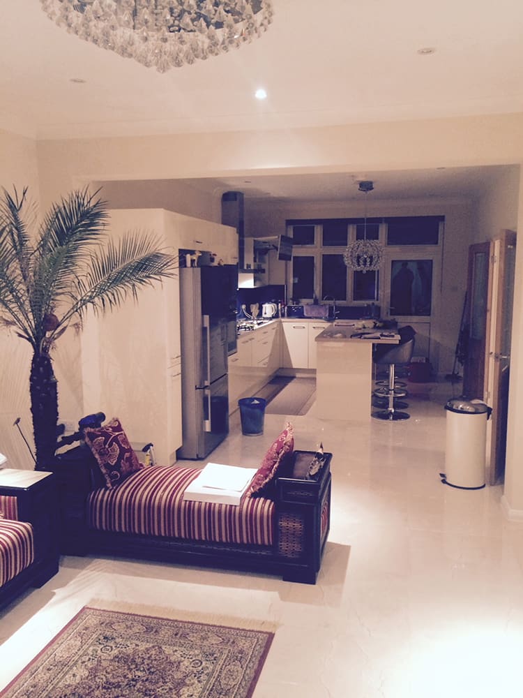 Open-plan refurbished interior with polished marble-effect floor