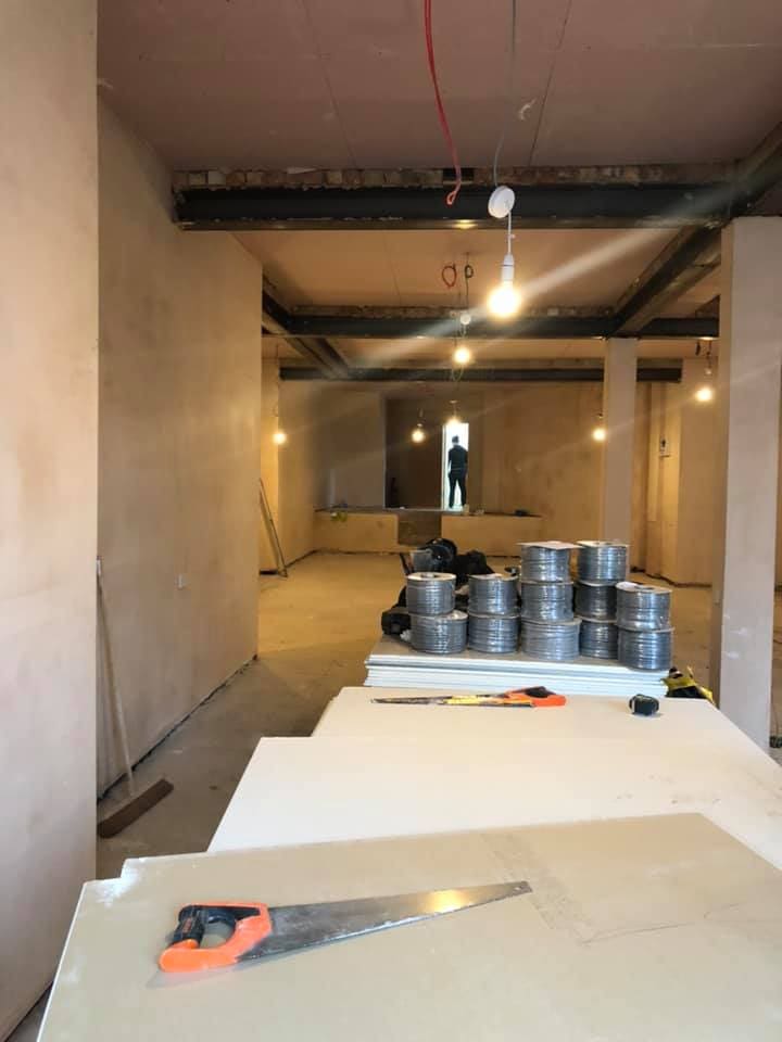Stripped retail unit with bare plaster and materials staged