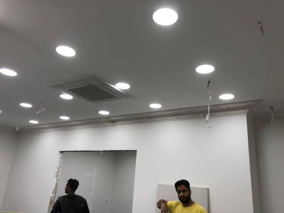 Decorators working under the new lighting scheme