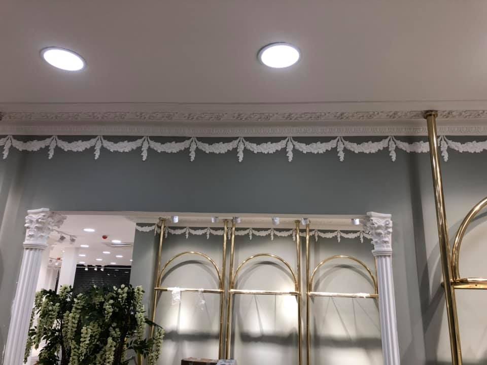 Ornate garland cornice installed at the ceiling line