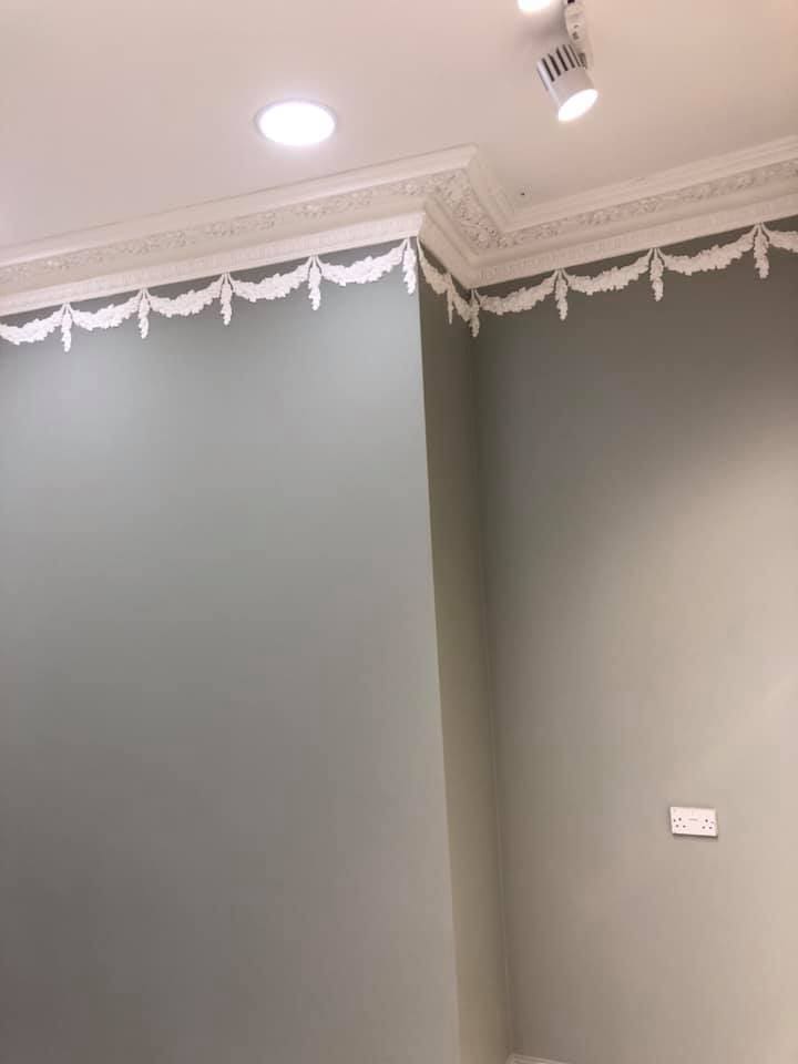 Finished decorative plasterwork above the display wall