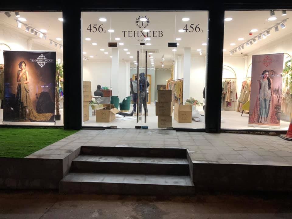Completed boutique shopfront glazed and lit at dusk
