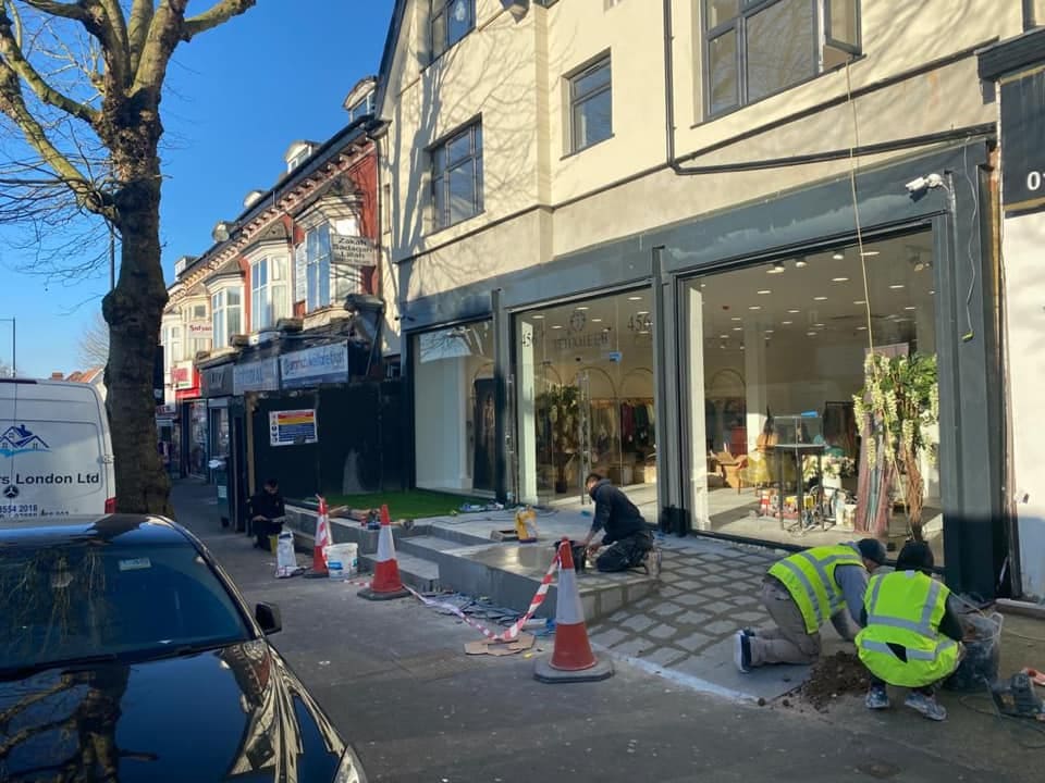 Team completing external works at the boutique frontage