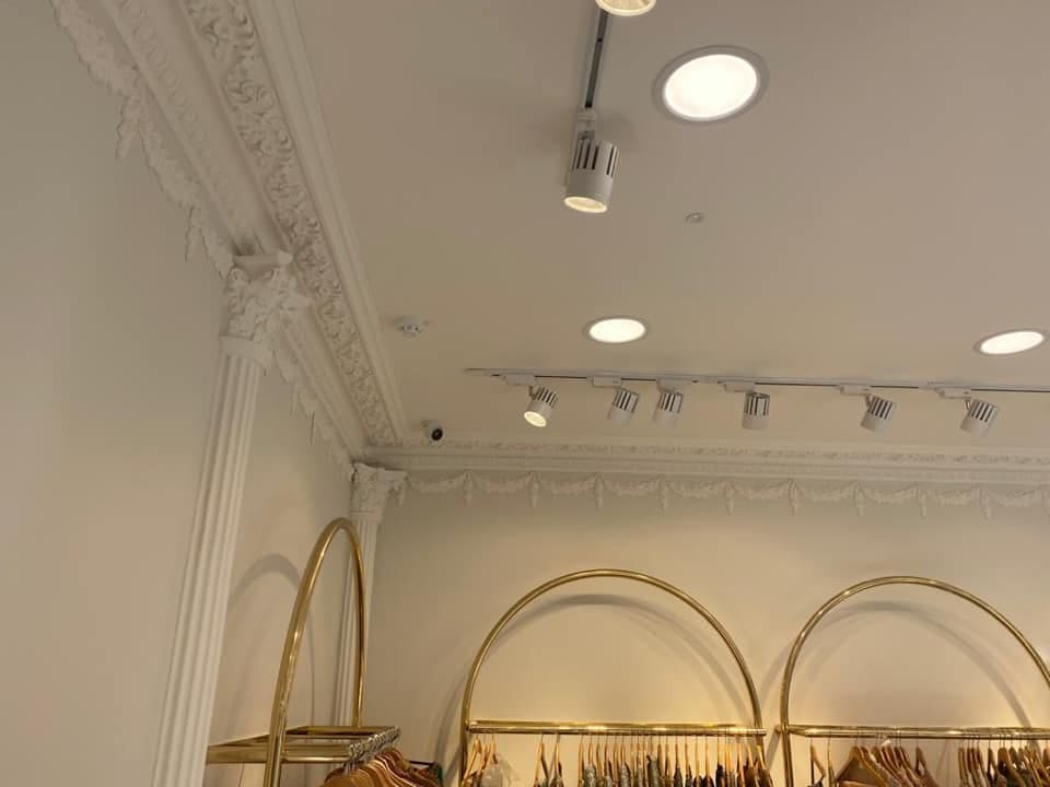 Gold display arches against white walls under the new lighting