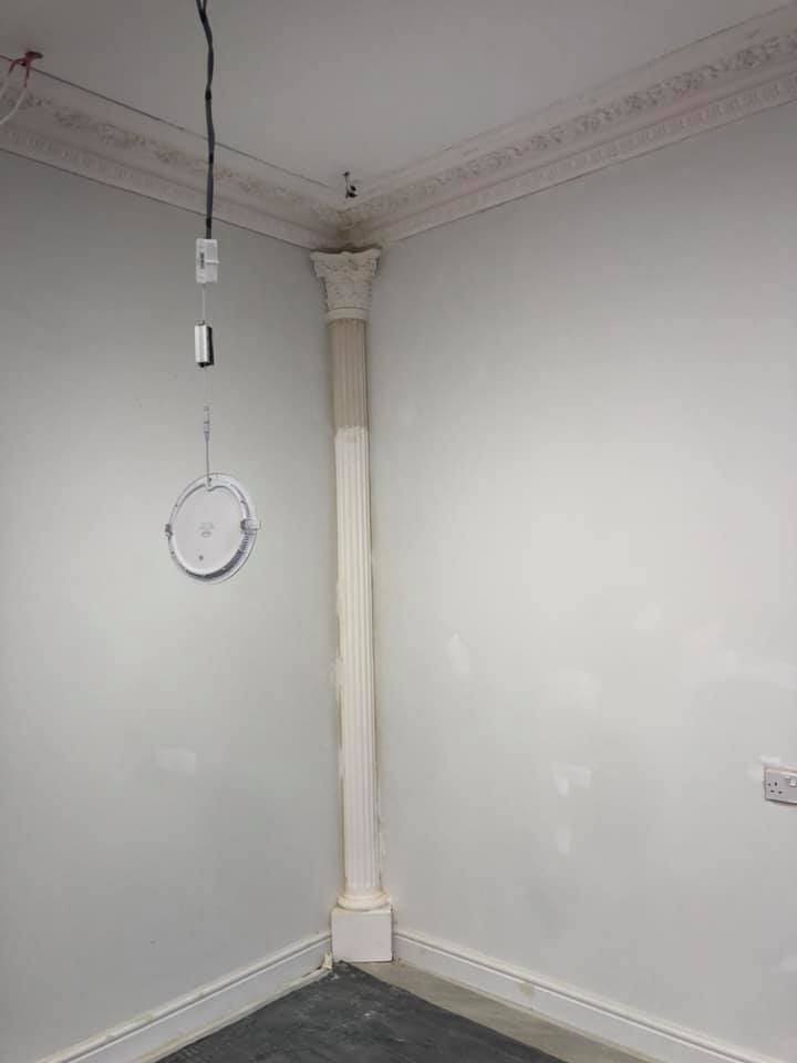 Corinthian column capital installed against the wall