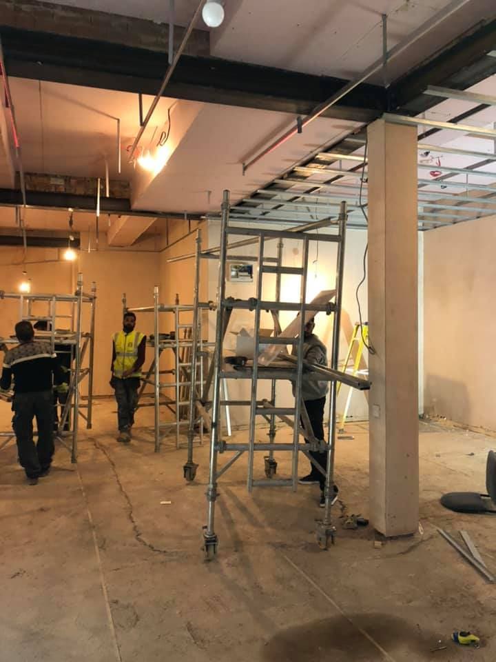 Team on scaffold tower installing the ceiling