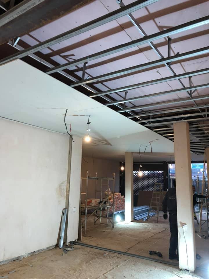 Boutique interior with display fixtures being positioned