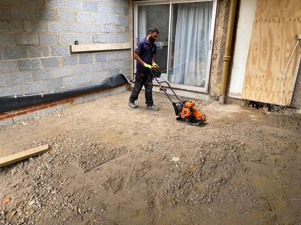Operative compacting hardcore sub-base with a plate compactor
