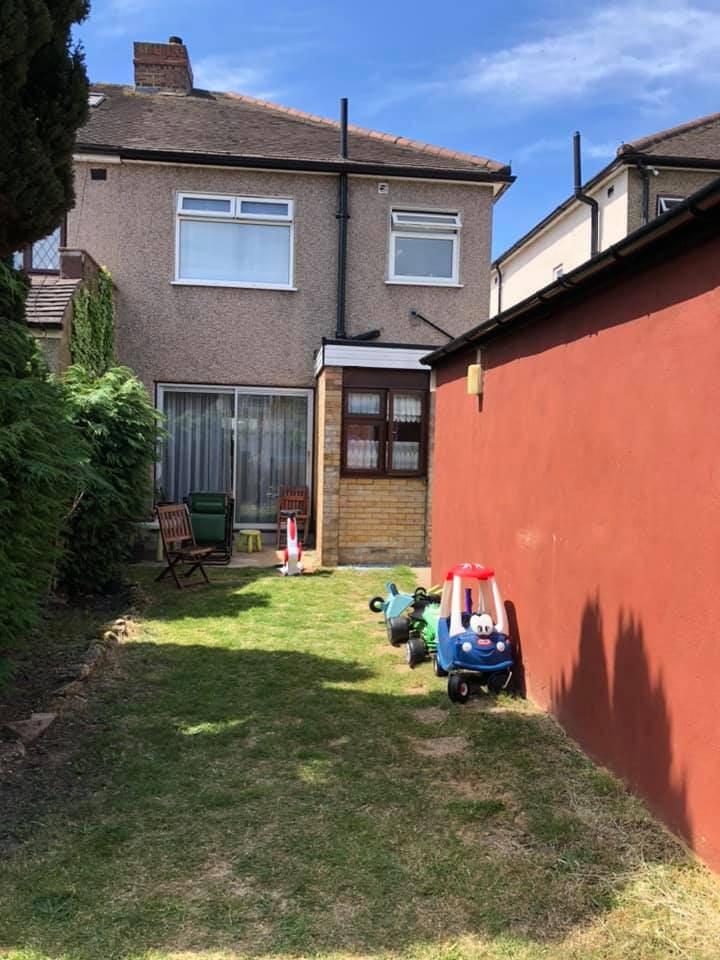 Rear garden with painted wall before landscaping works
