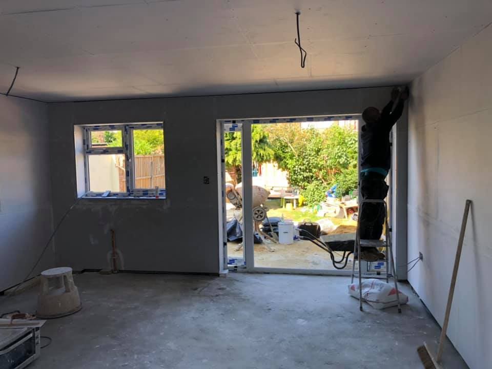 Plastered open-plan extension interior with French doors to the garden