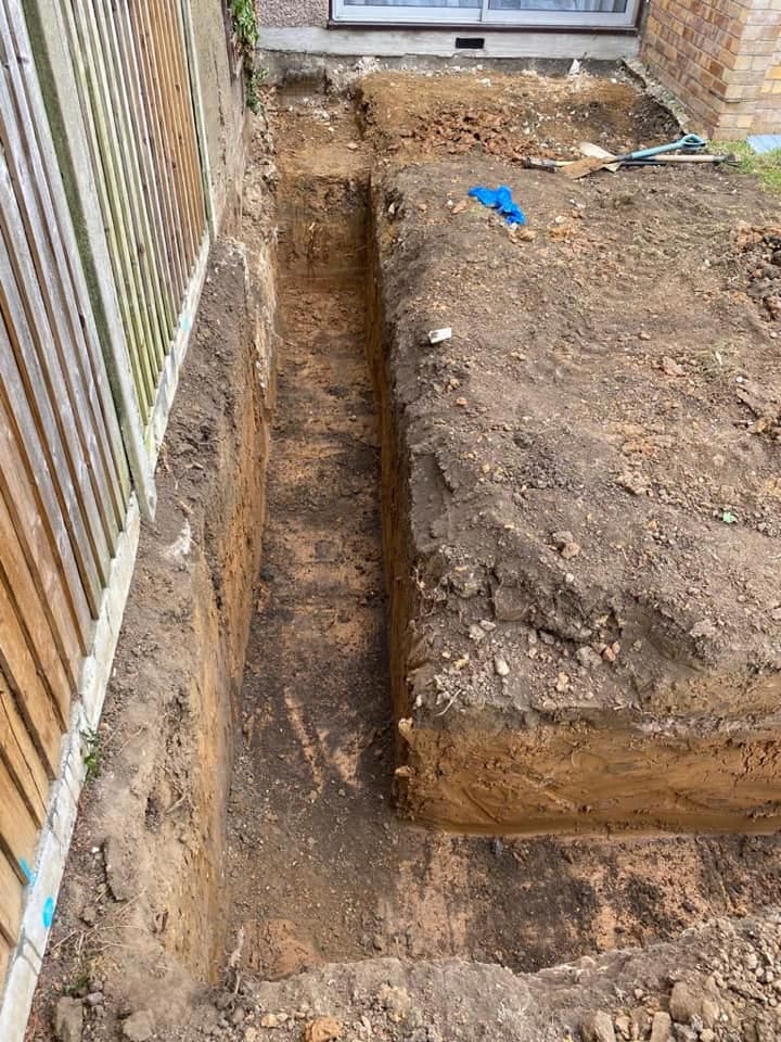 Excavated foundation trench in London clay awaiting inspection and concrete