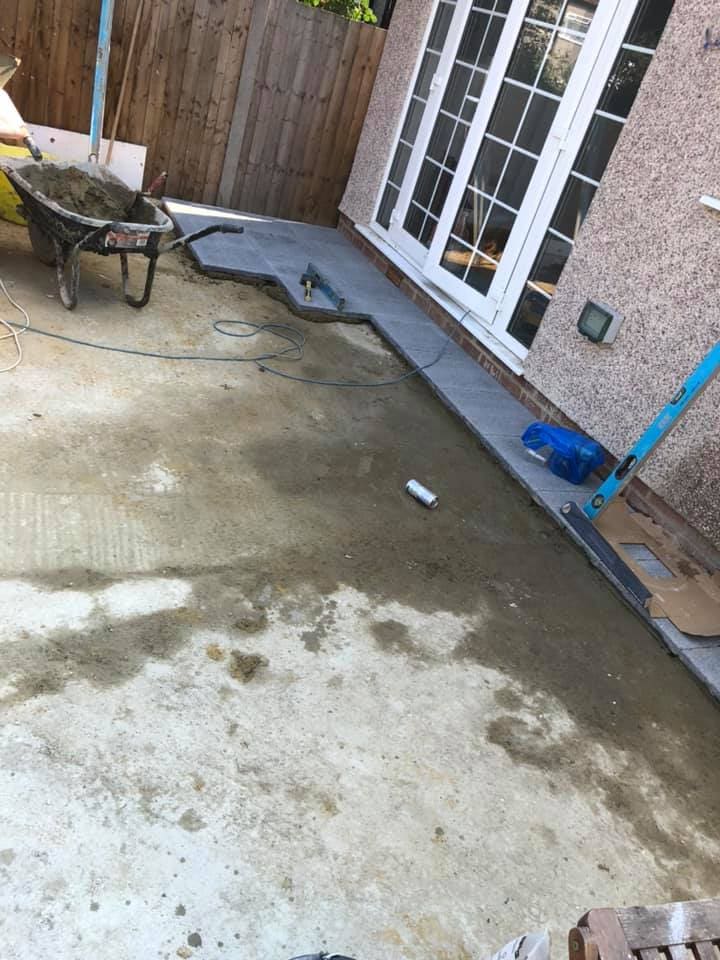 New patio and rendered garden walls behind the finished extension