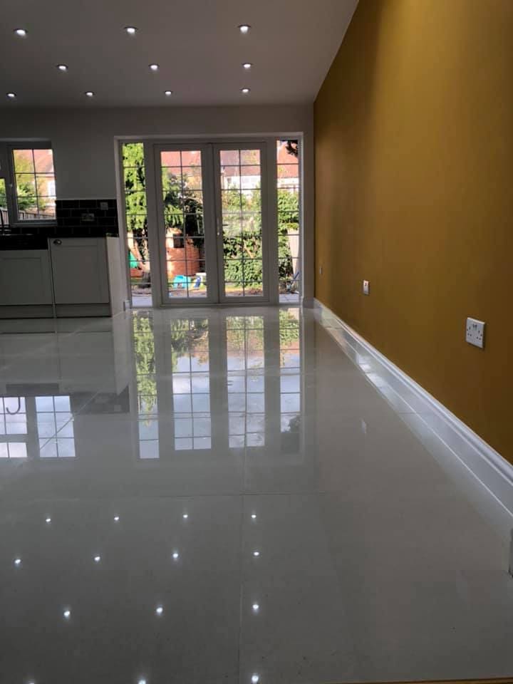 Polished floor tiles reflecting light from the garden doors