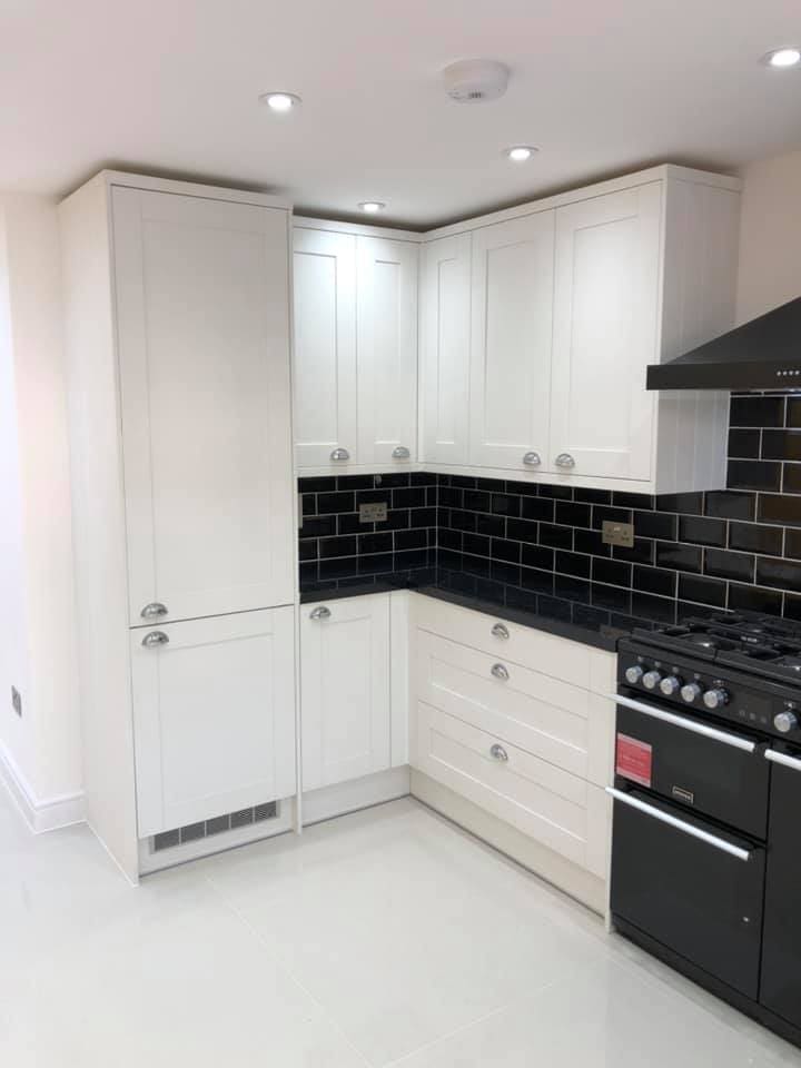 White kitchen with black metro tile splashback and range cooker