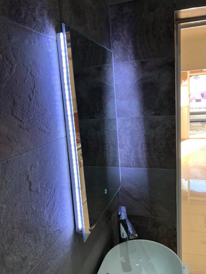 Stone-effect tiling running full height in the bathroom