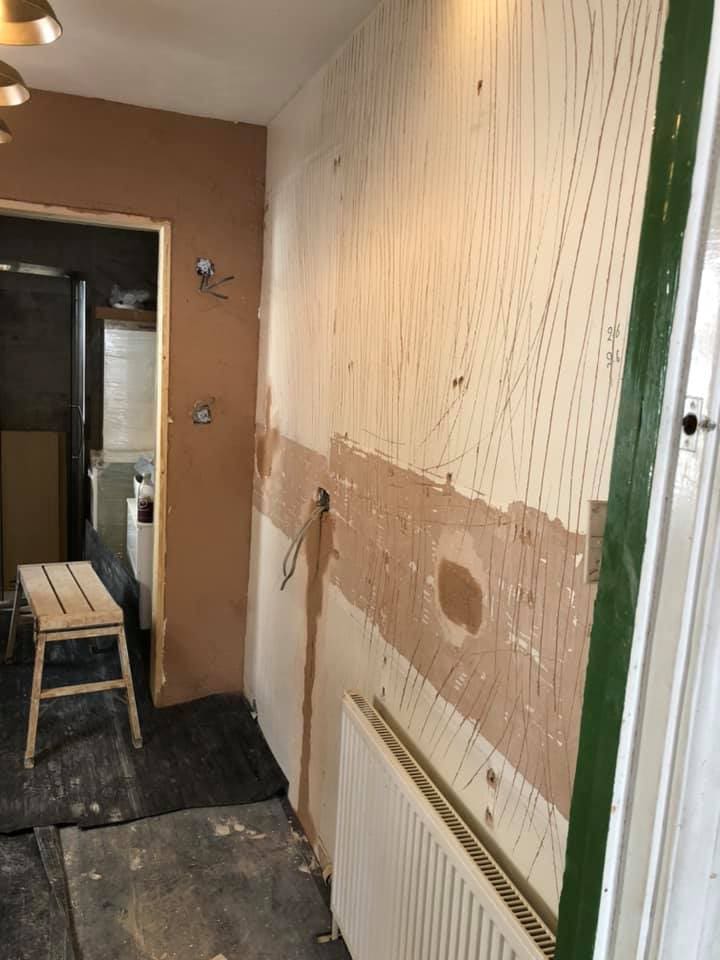 Kitchen walls stripped to bare plaster during refit